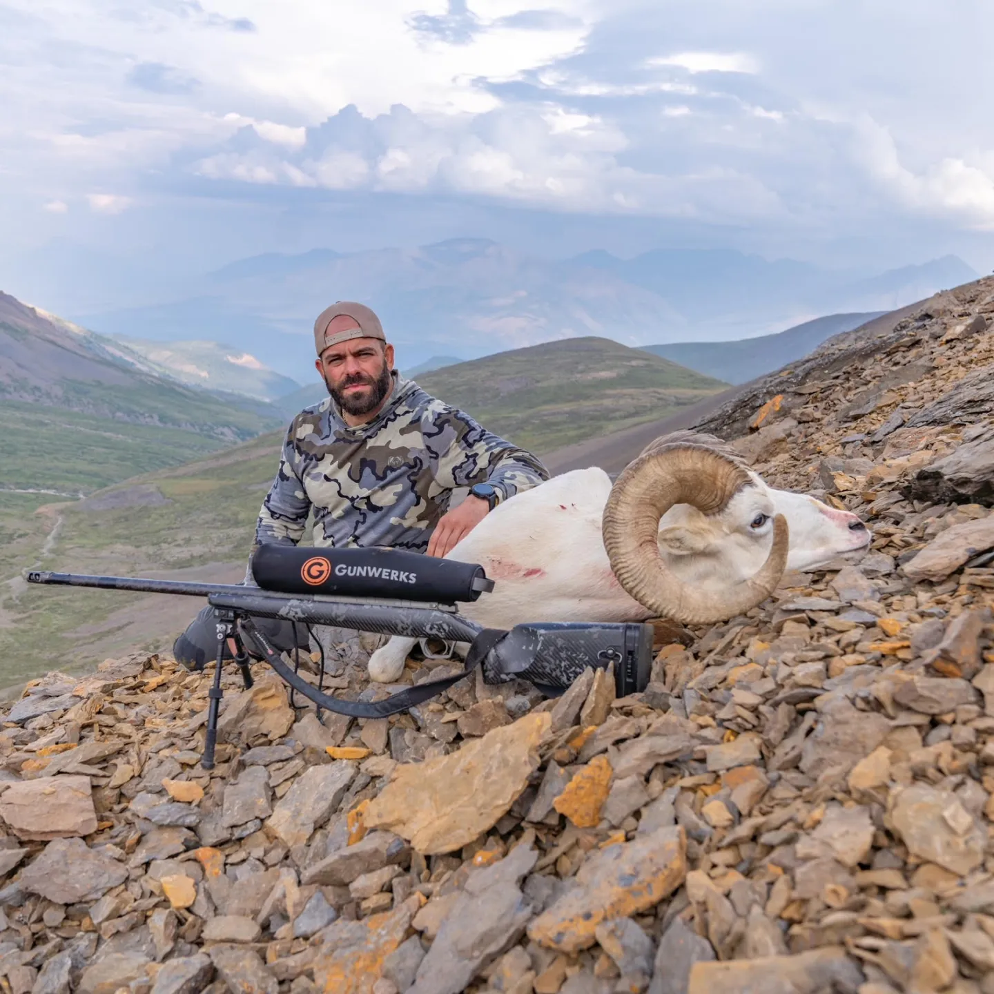 Gunwerks customer with a white Dall ram in a mountainous region