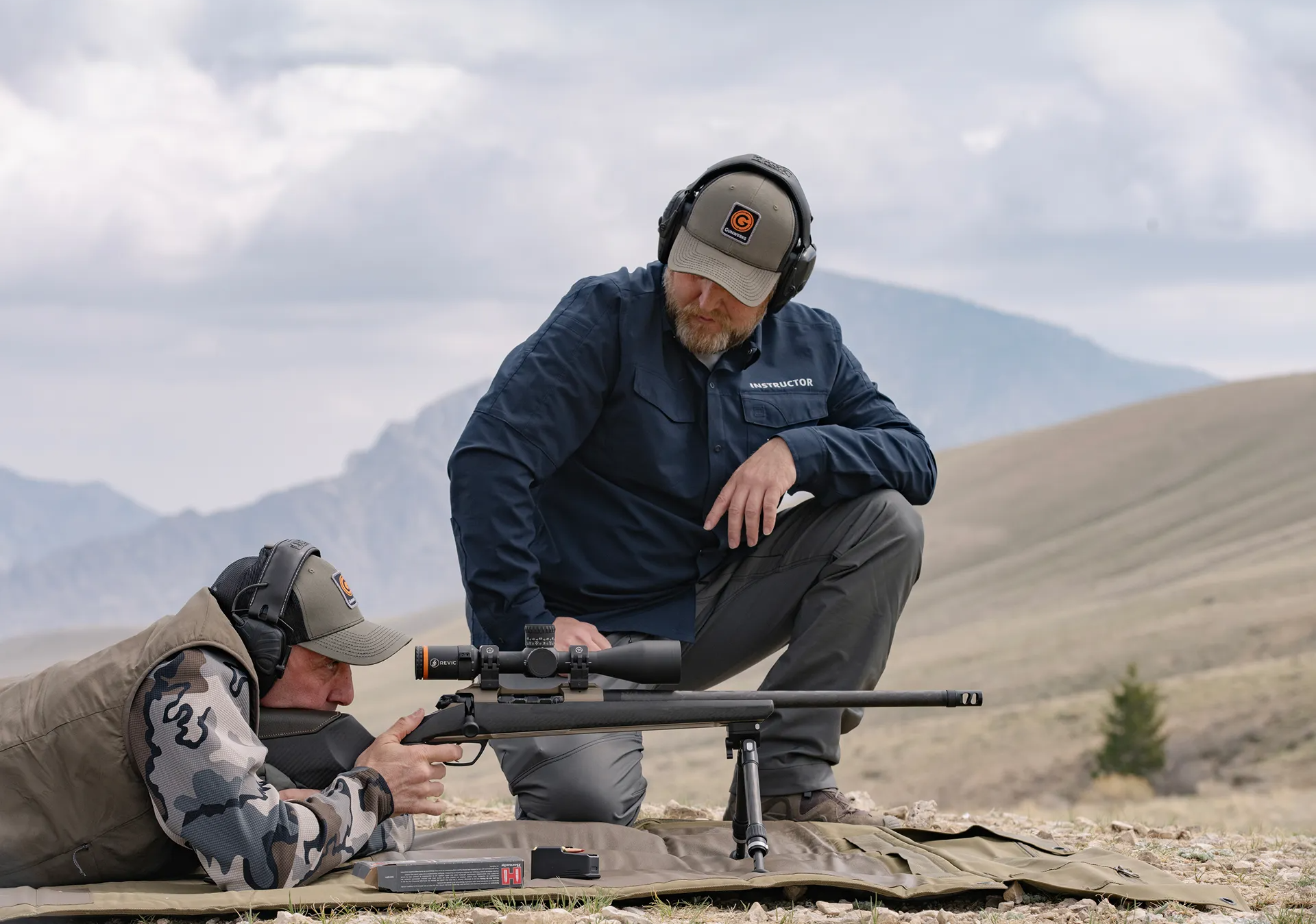 An long range rifle instructor teaching an LRU student.